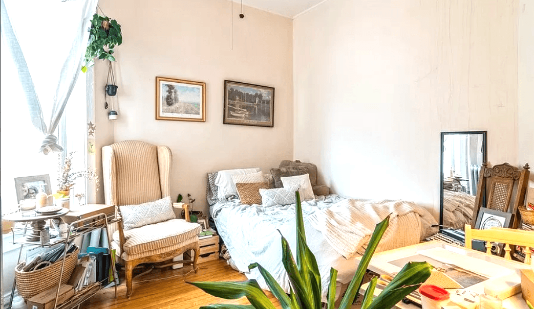 a bedroom with a bed and a desk and a window